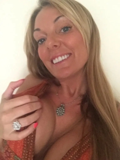 Sultry MILF with Massive Silicone Tits Exposed in Amateur Photo